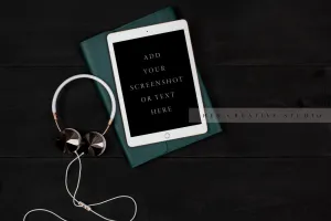Tablet, Headphones & Notebook on Black Background